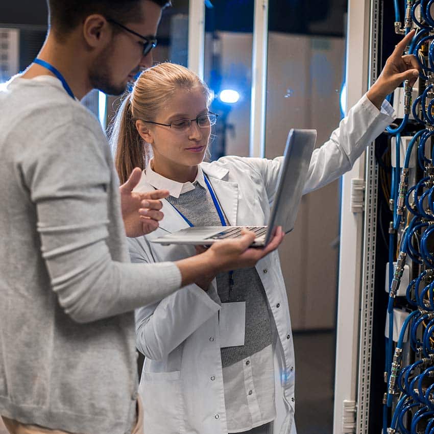 People with laptop working on server